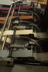 loom producing woven jacquard ribbons from fine silk thread